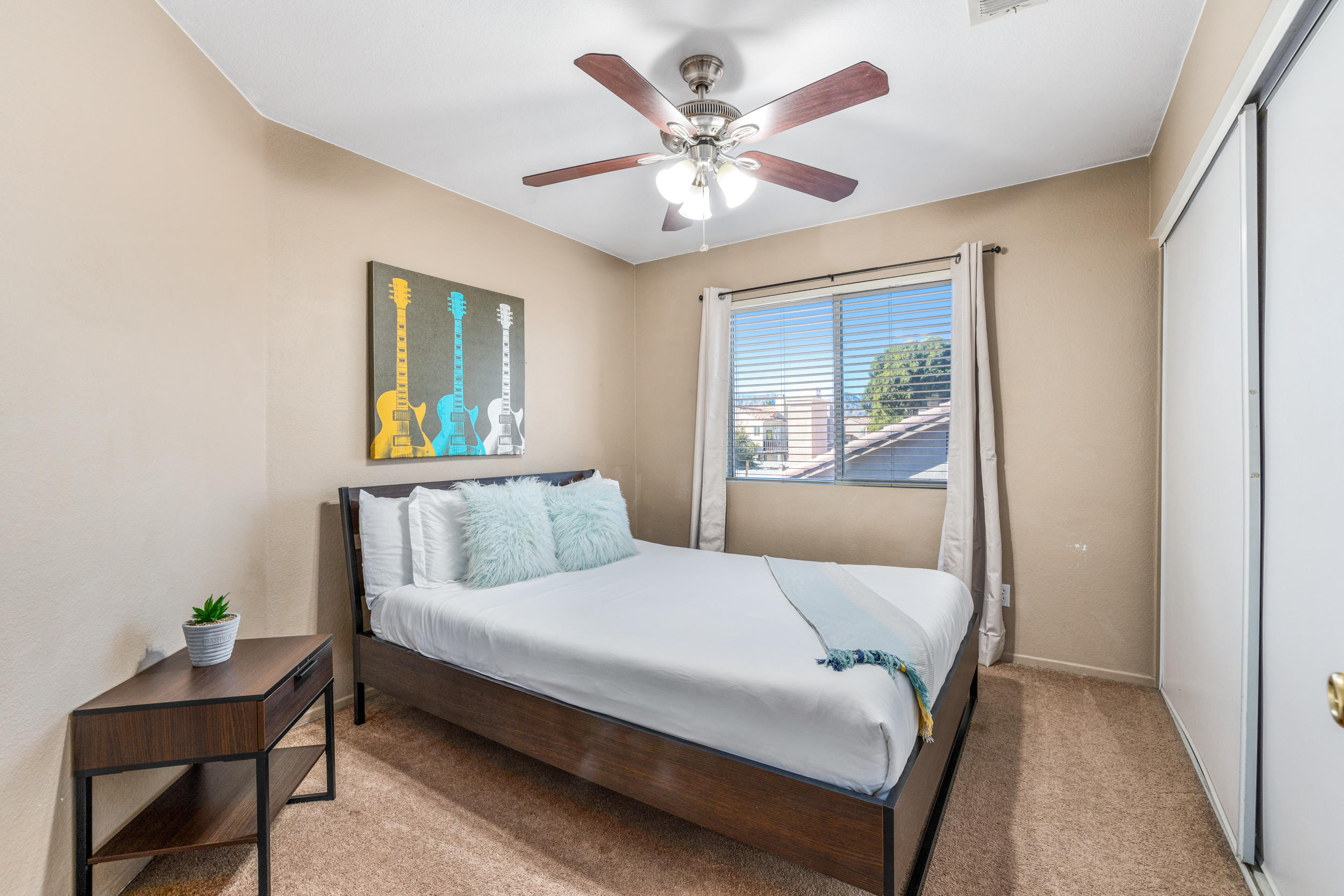 80721 Sycamore Lane Indio, CA 92201 - Photo 17 of 35 a bedroom with a bed and a table