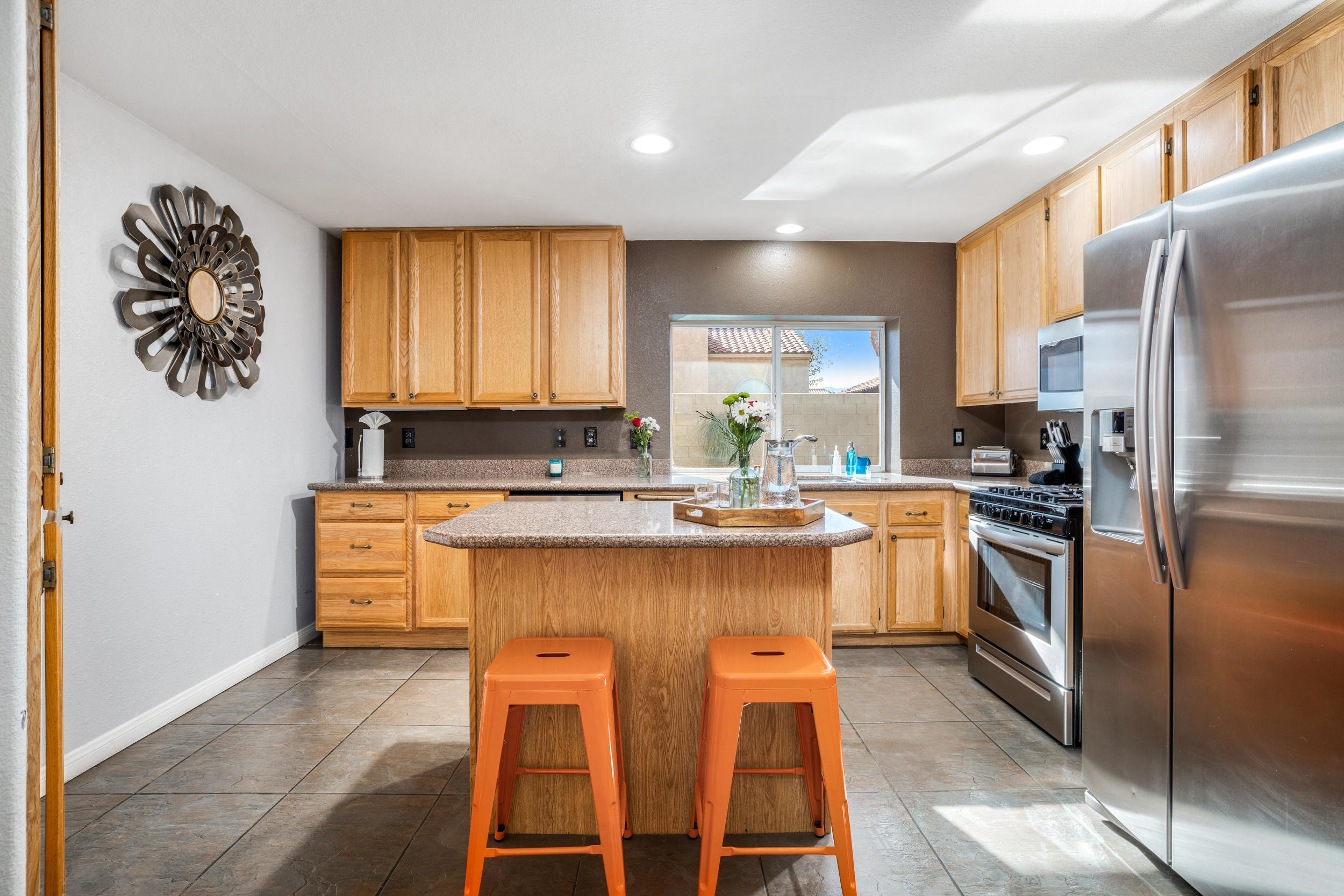 80721 Sycamore Lane Indio, CA 92201 - Photo 24 of 35 a kitchen with stainless steel appliances granite countertop a stove a sink and a refrigerator