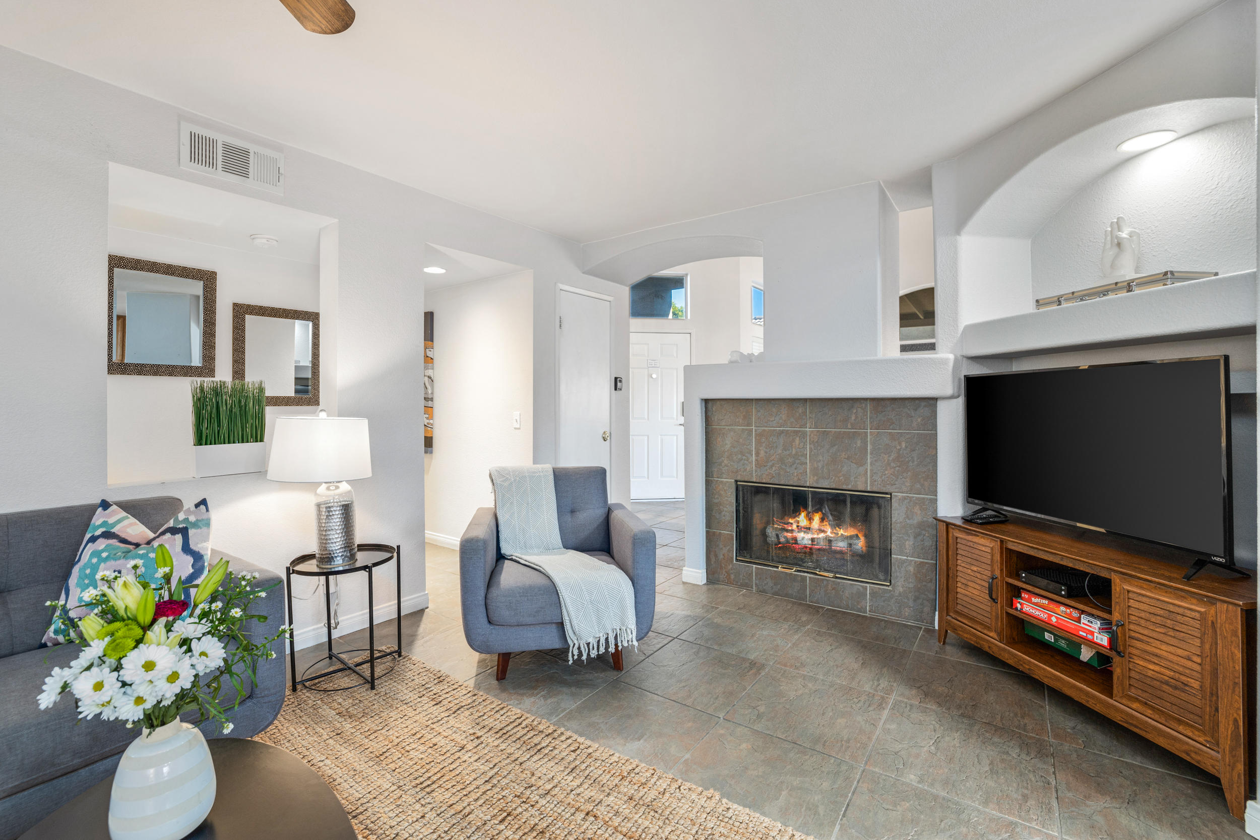 80721 Sycamore Lane Indio, CA 92201 - Photo 26 of 35 a living room with furniture a flat screen tv and a fireplace
