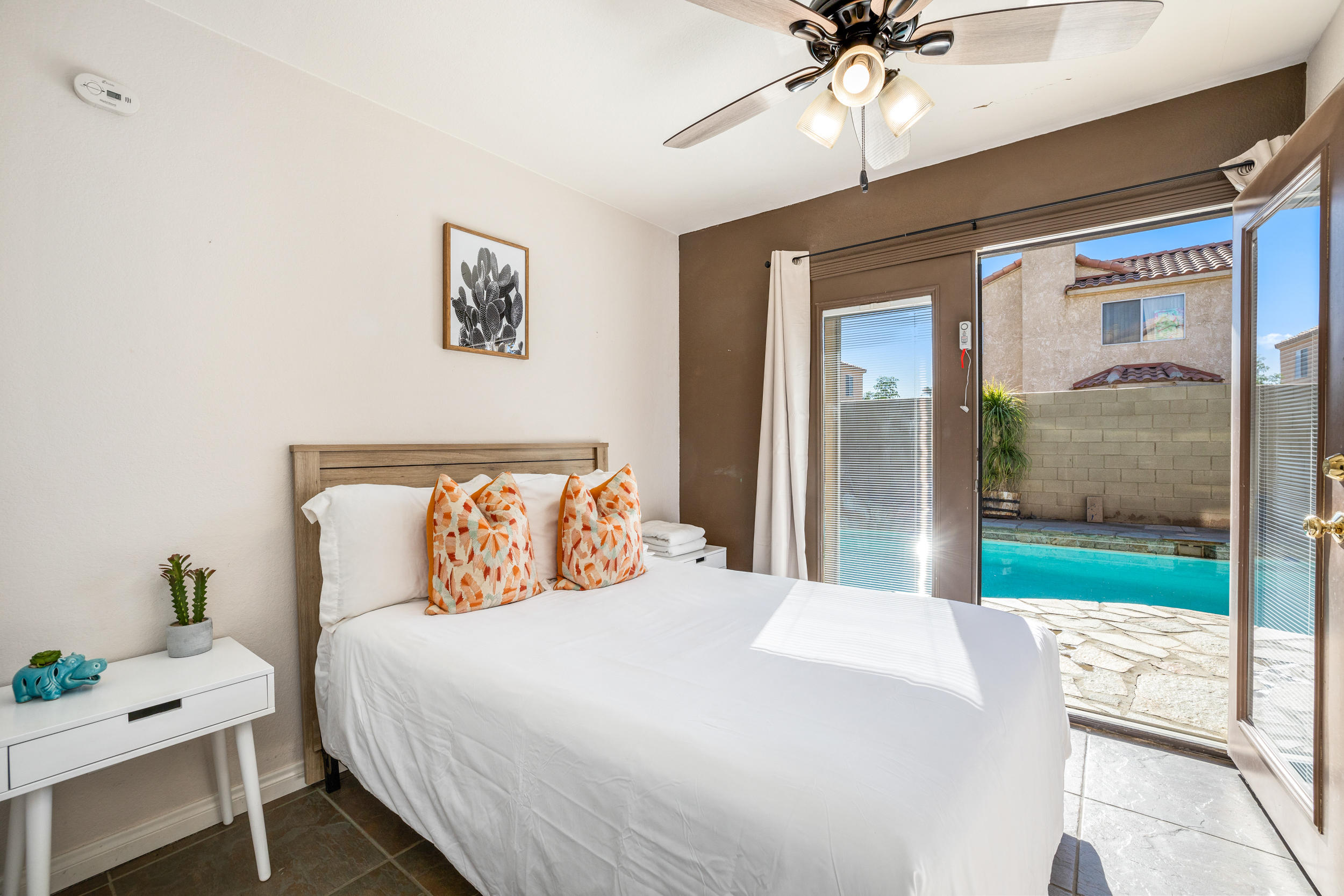 80721 Sycamore Lane Indio, CA 92201 - Photo 28 of 35 a bedroom with a bed and a chandelier