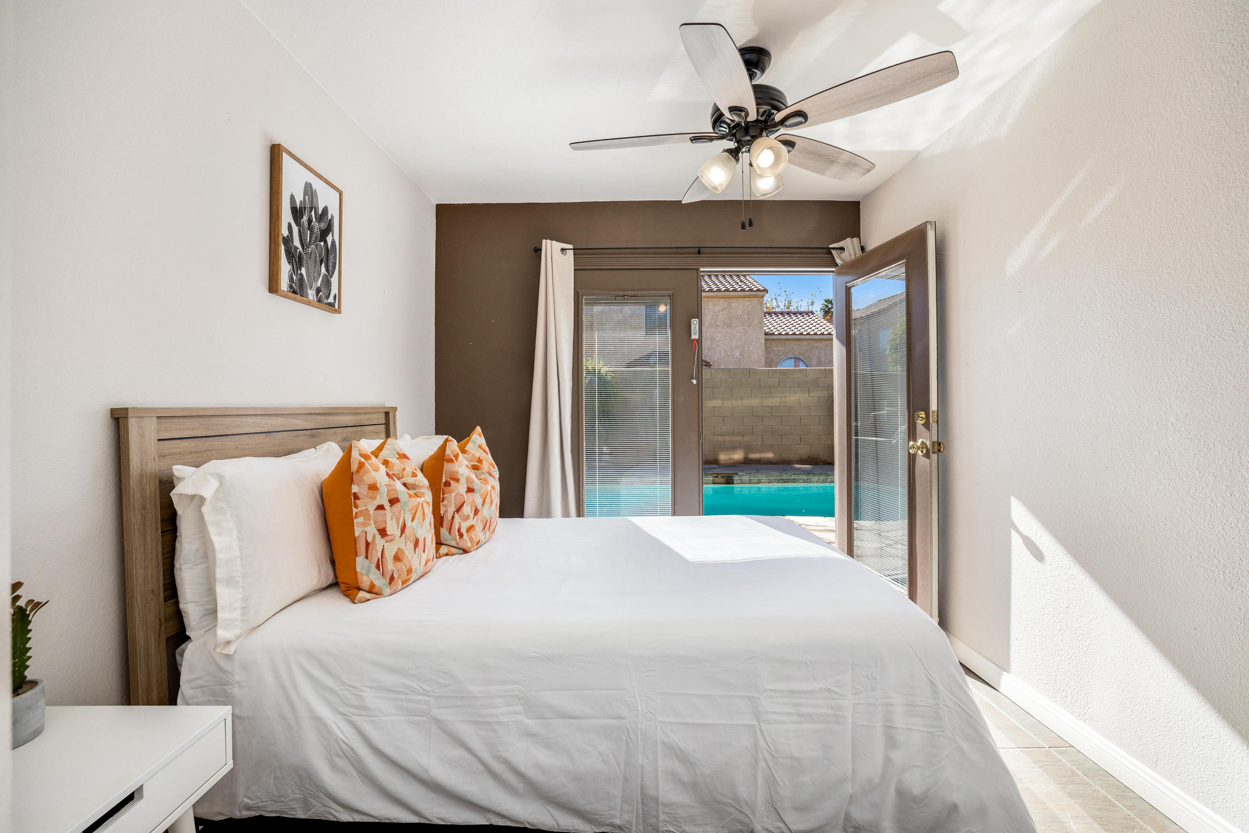 80721 Sycamore Lane Indio, CA 92201 - Photo 29 of 35 a bedroom with a large bed and a chandelier