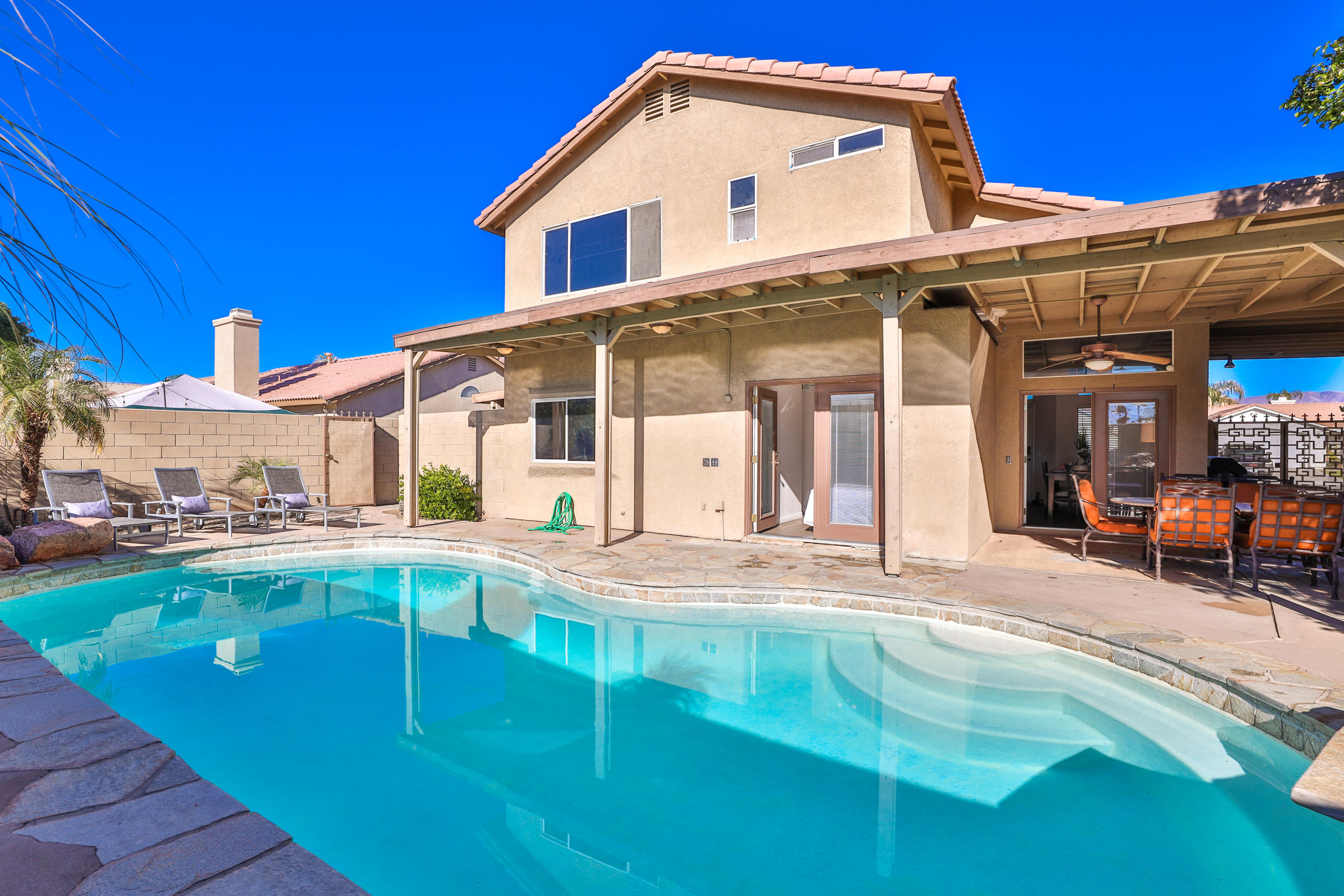 80721 Sycamore Lane Indio, CA 92201 - Photo 32 of 35 a view of a house with pool and chairs