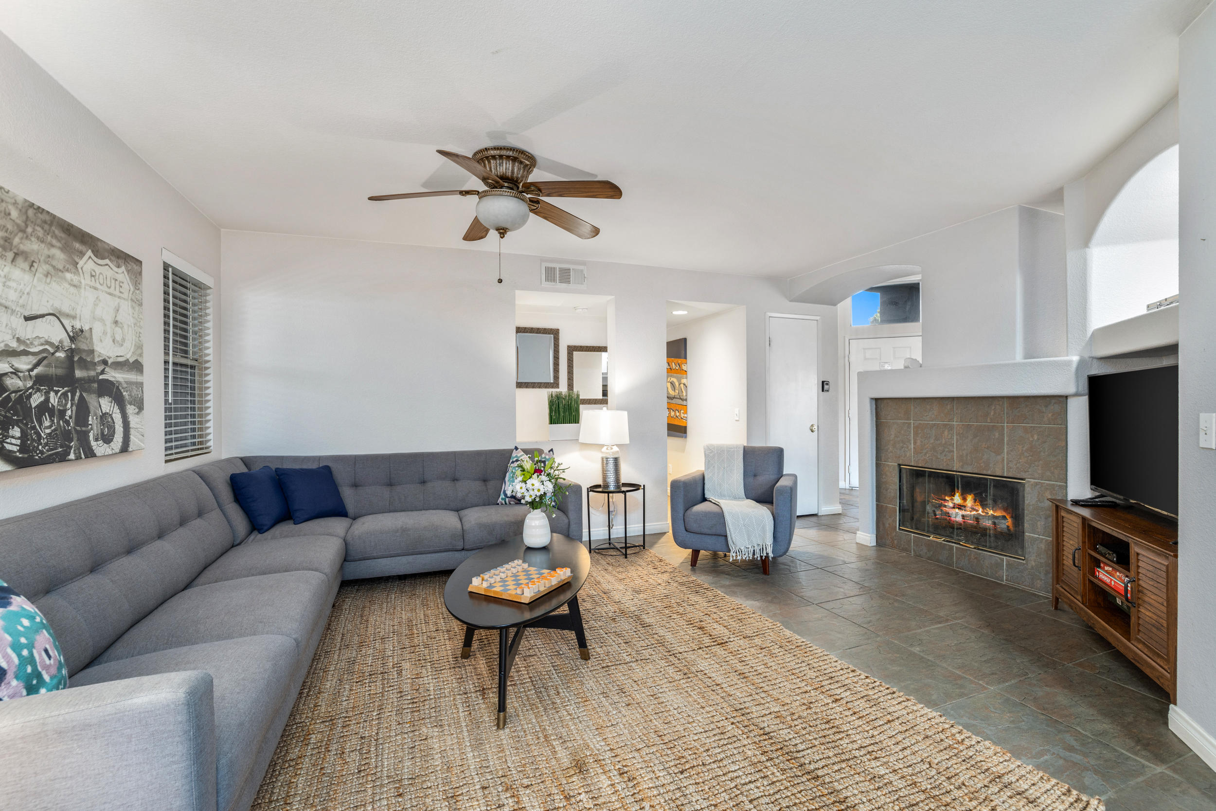 80721 Sycamore Lane Indio, CA 92201 - Photo 7 of 35 a living room with furniture a fireplace and a flat screen tv