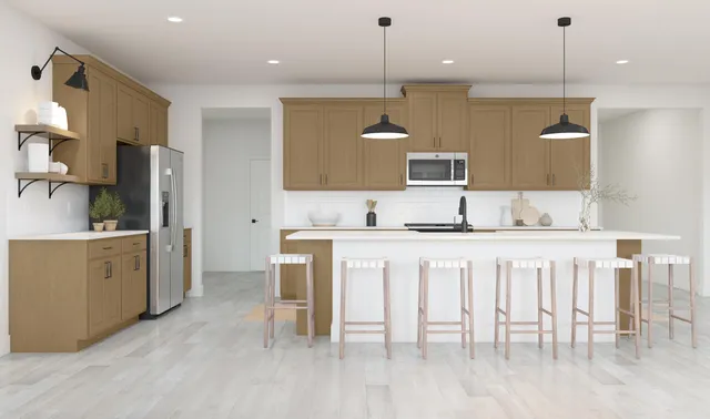 a large kitchen with kitchen island a chandelier and view of living room