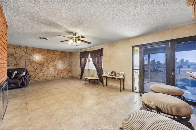 a bedroom with furniture and a large window