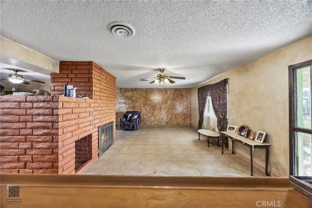 a view of a livingroom with furniture and a ceiling fan