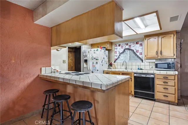 a kitchen with a stove top oven sink and cabinets