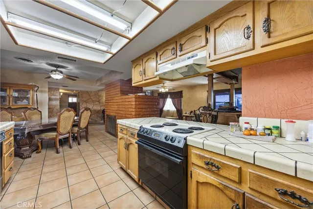 a view of a hallway and a livingroom with furniture