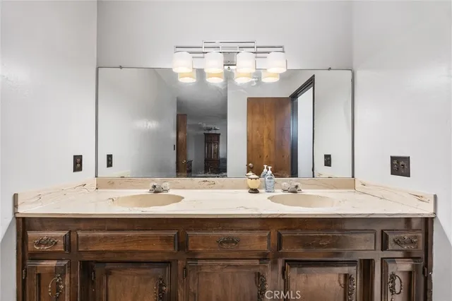 a bathroom with a sink double vanity and a mirror