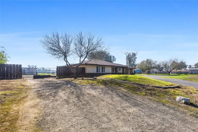 a view of a swimming pool with a yard and plants