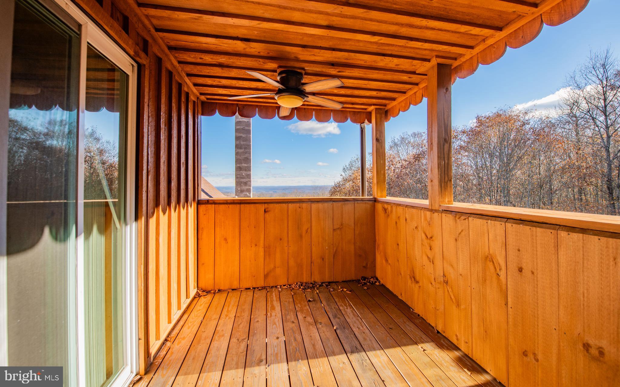 115 Glory Rdg Road Shunk, PA 17768 - Photo 18 of 35 Serene wooden balcony with scenic views.