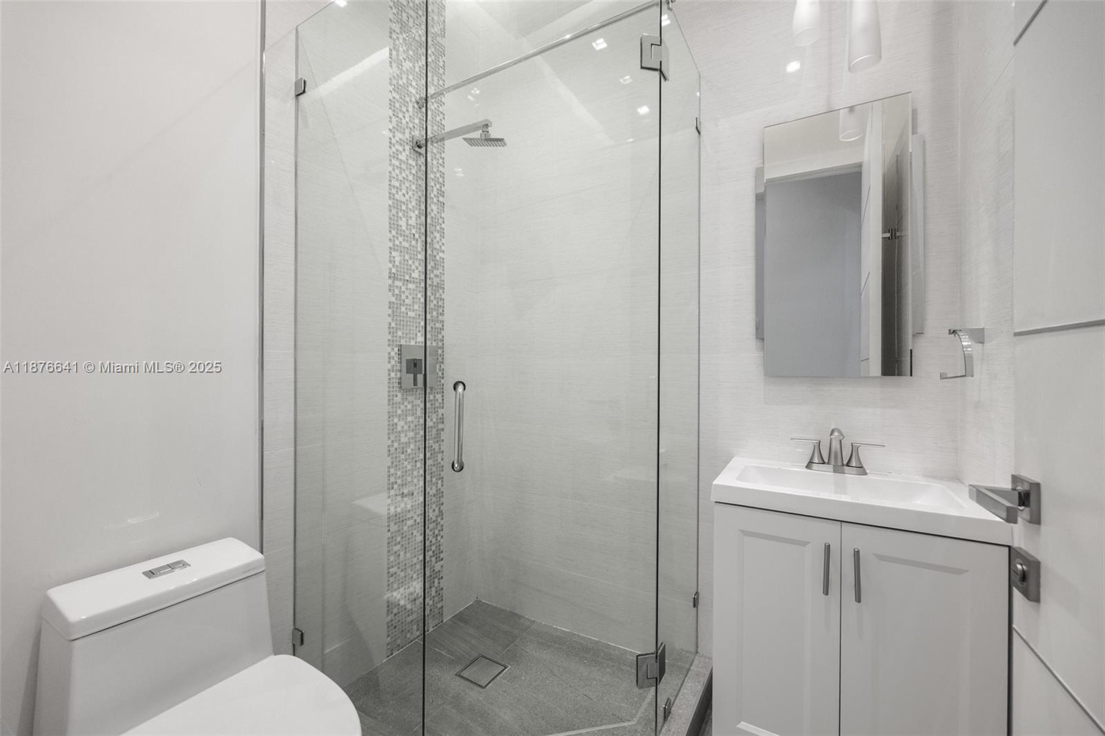 2321 Trapp Avenue Coconut Grove, FL 33133 - Photo 14 of 38 a bathroom with a toilet sink vanity and shower