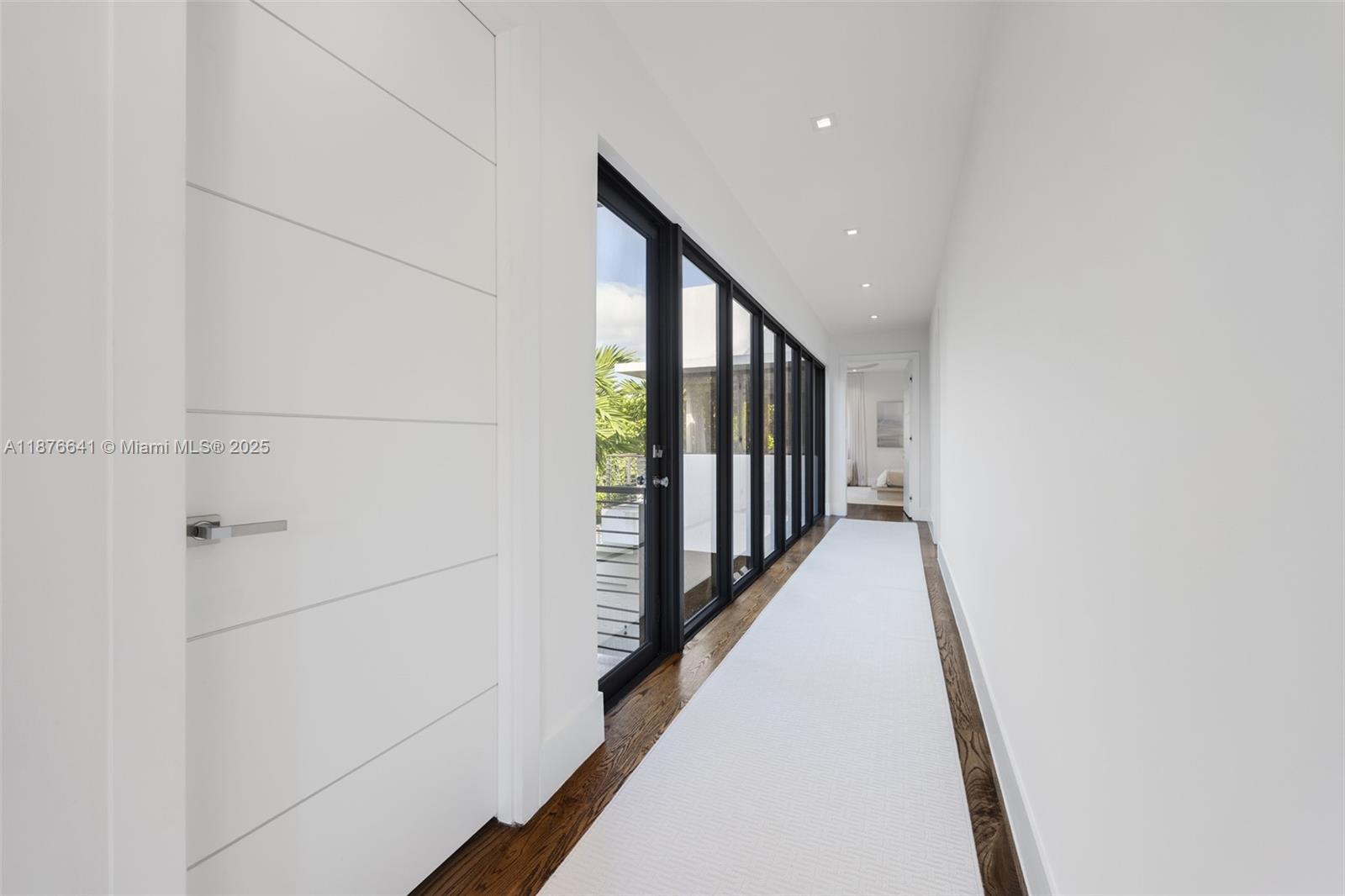 2321 Trapp Avenue Coconut Grove, FL 33133 - Photo 18 of 38 a hallway with wooden floor in a house