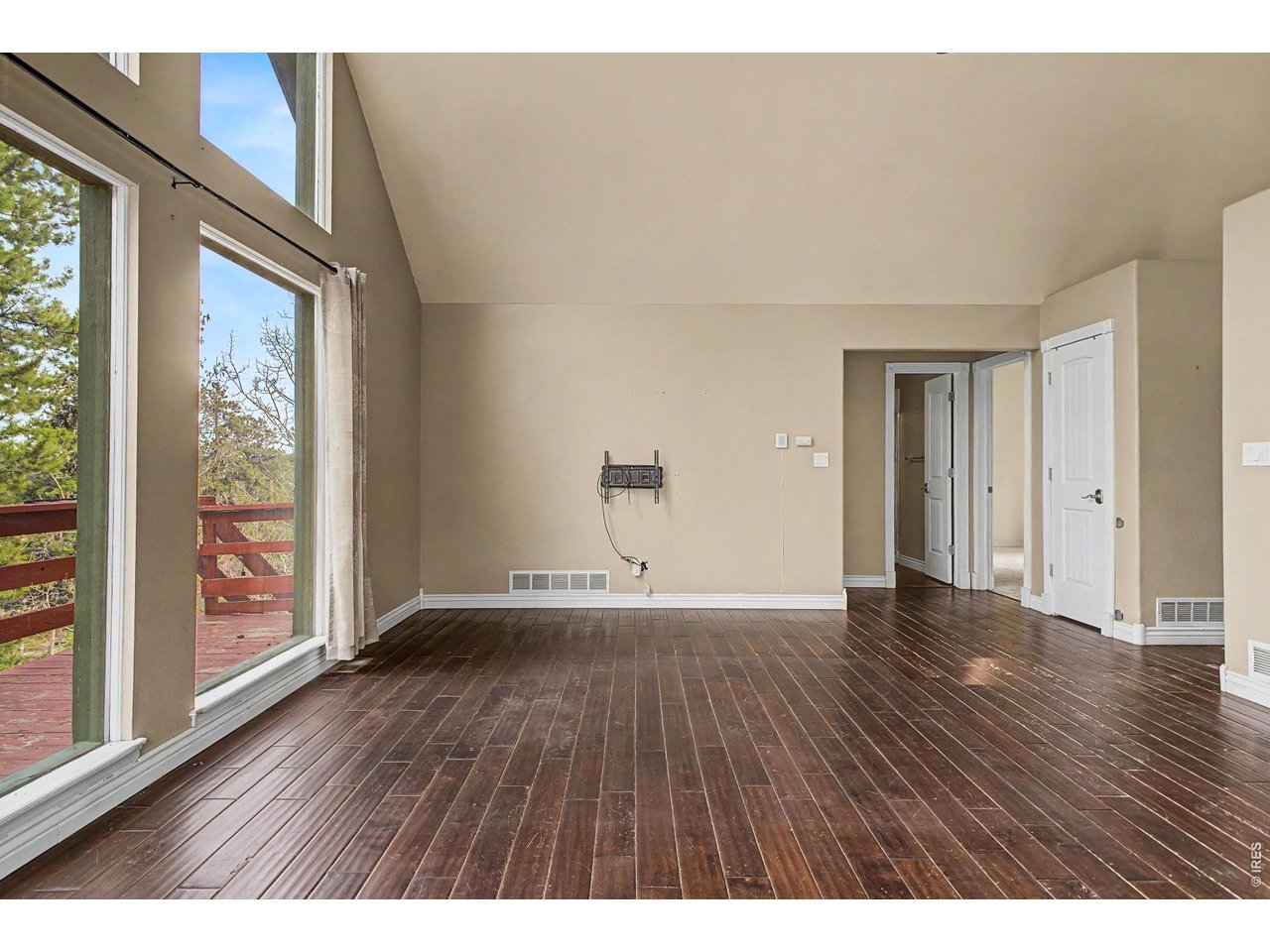 76 Highlands Drive Bailey, CO 80421 - Photo 16 of 49 a view of an empty room with wooden floor and a window