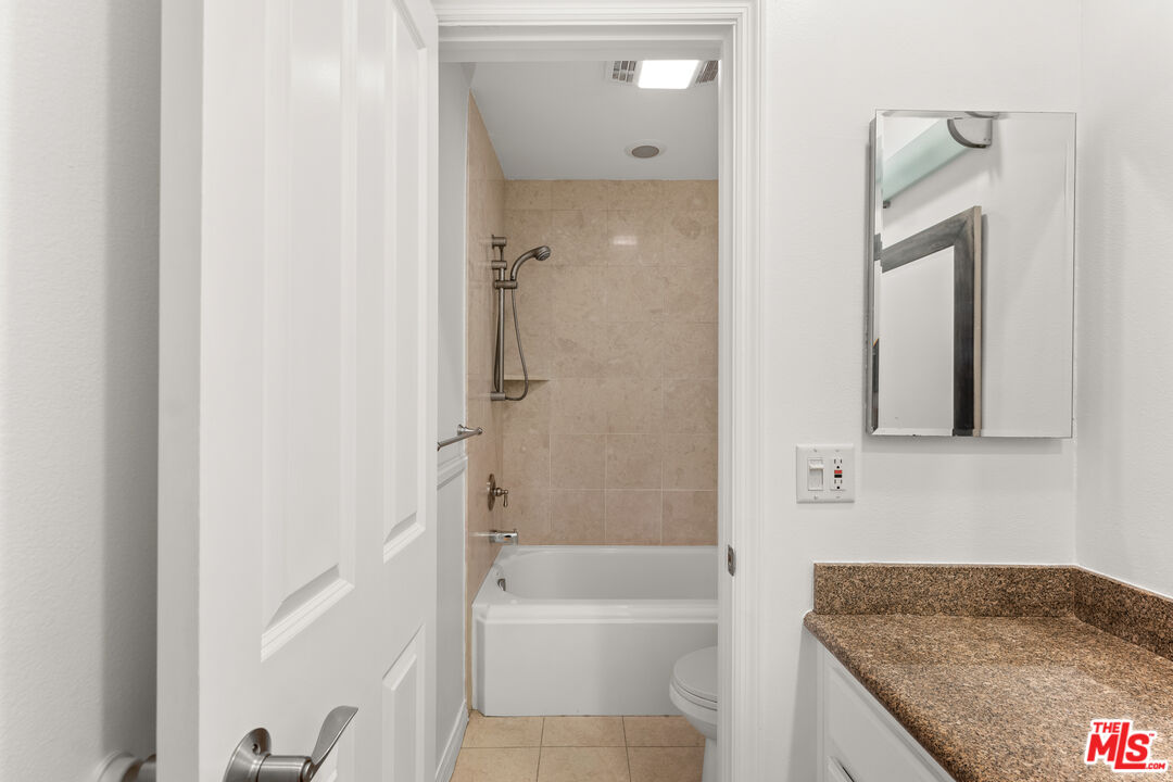 7202 Raintree Circle Culver City, CA 90230 - Photo 12 of 17 a bathroom with a granite countertop bathtub shower and sink