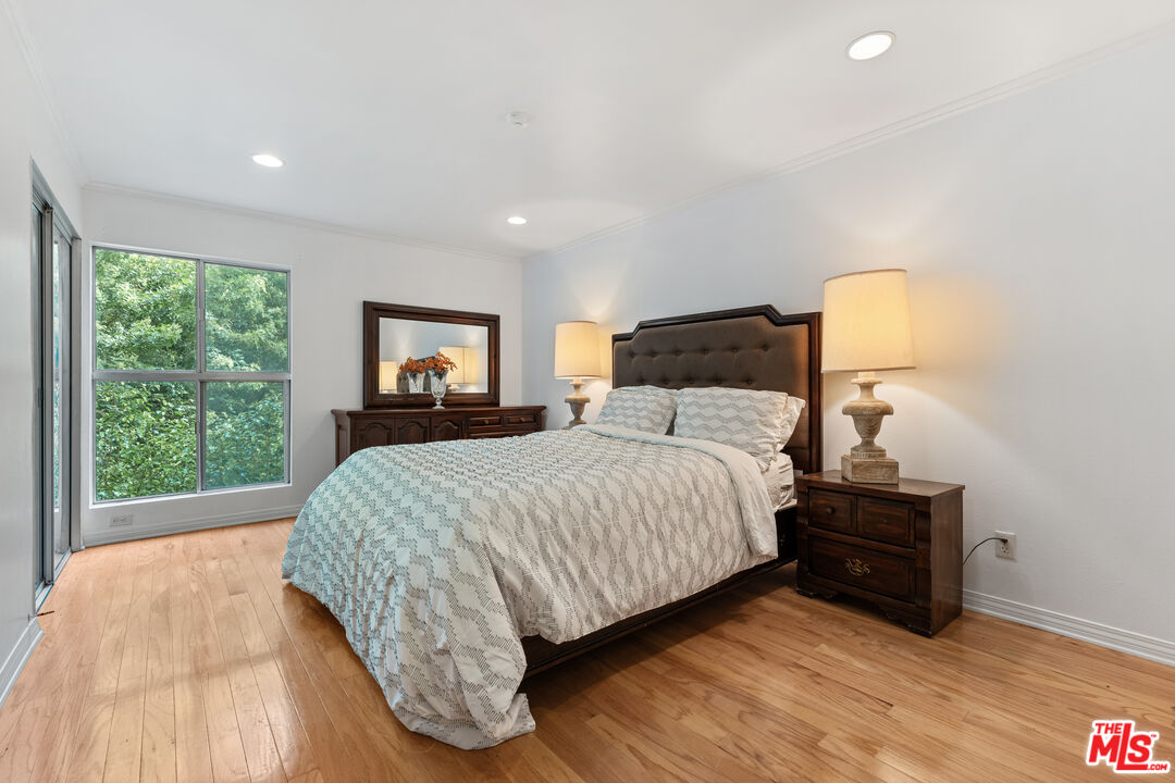 7202 Raintree Circle Culver City, CA 90230 - Photo 6 of 17 a bedroom with a bed and a large window
