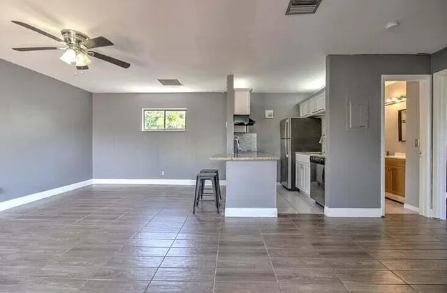 a view of kitchen with furniture and refrigerator