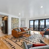 a living room with furniture and a floor to ceiling window