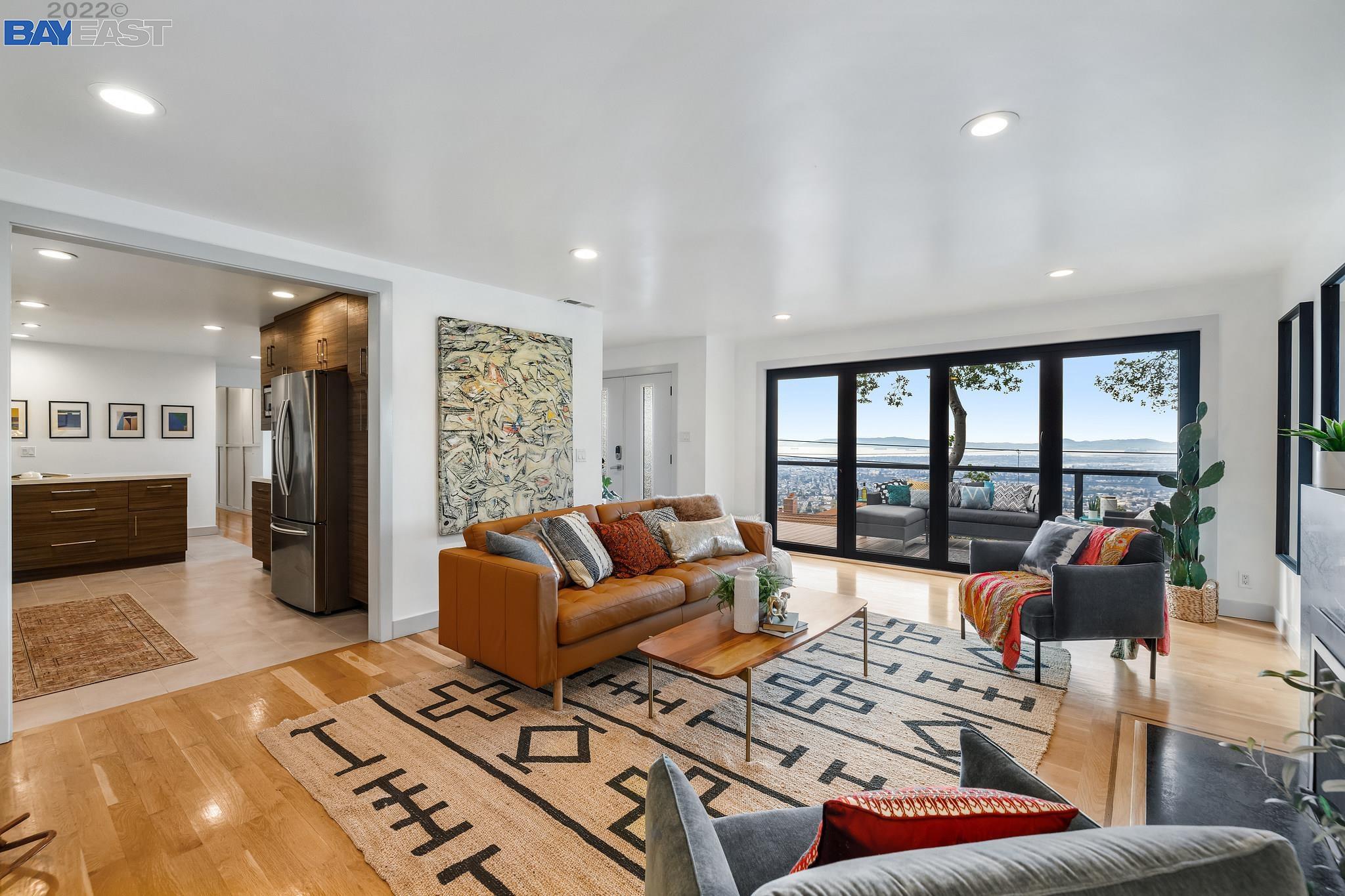 a living room with furniture and a floor to ceiling window