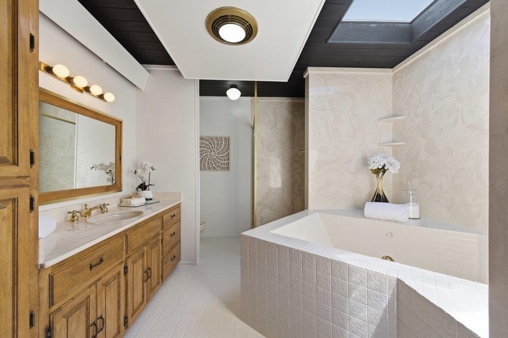 2203 Allegheny Way San Mateo, CA 94402 - Photo 21 of 56 a bathroom with a tub sink and mirror