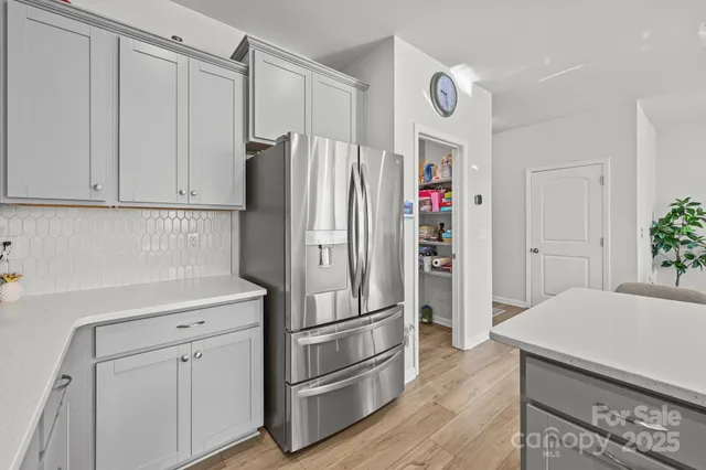 a kitchen with stainless steel appliances a refrigerator and cabinets