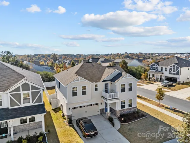 a view of a white house with a big yard and a large window