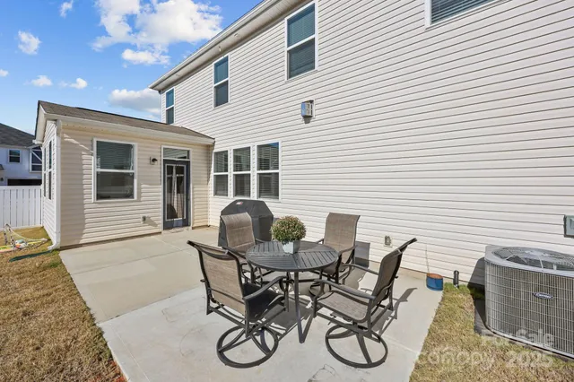 a view of a patio with couches table and chairs and potted plants