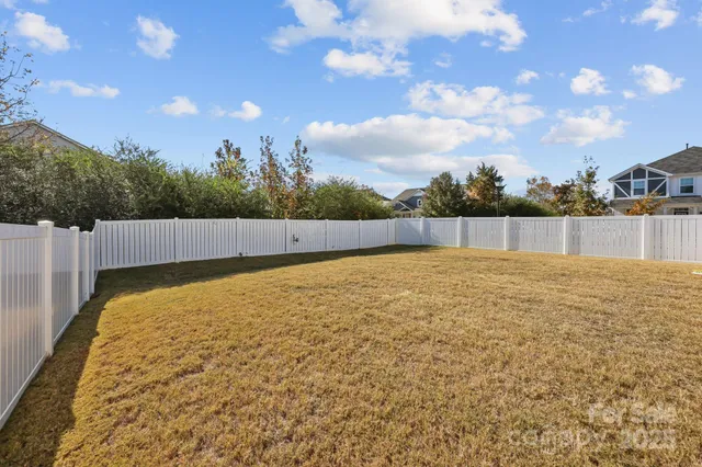 a view of house with yard and sitting area