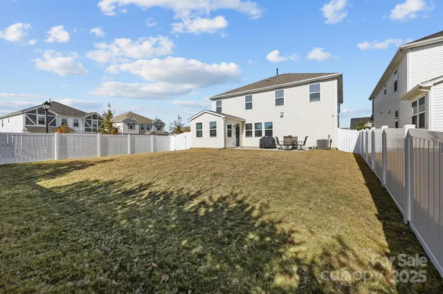 a view of a white house with a yard