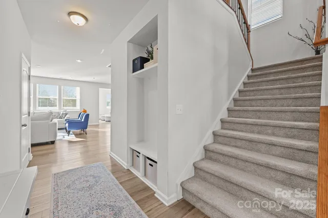 a view of entryway and hall with wooden floor