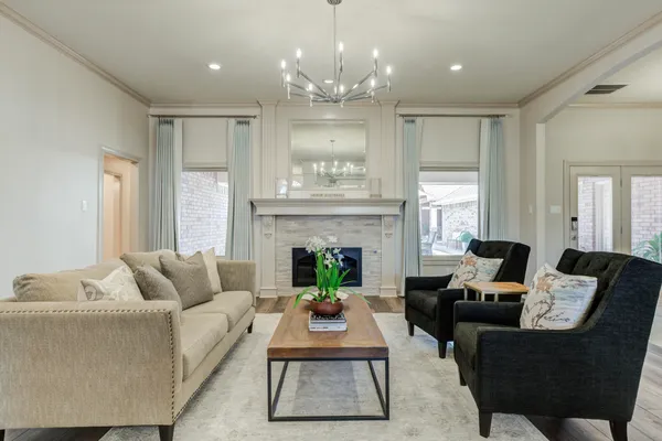 a living room with furniture and a chandelier