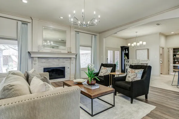 a living room with furniture and a chandelier