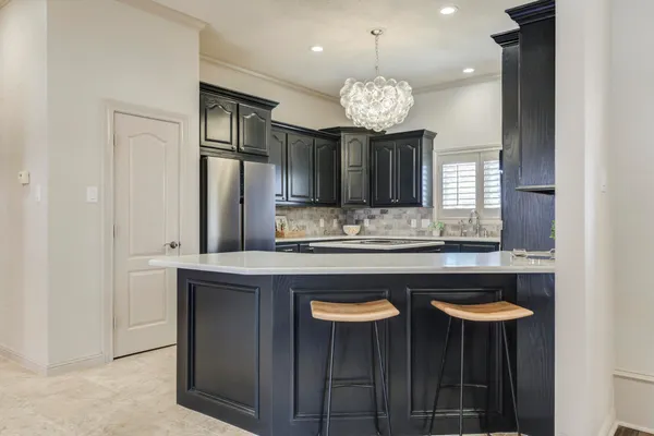 a kitchen that has a sink and a stove in it