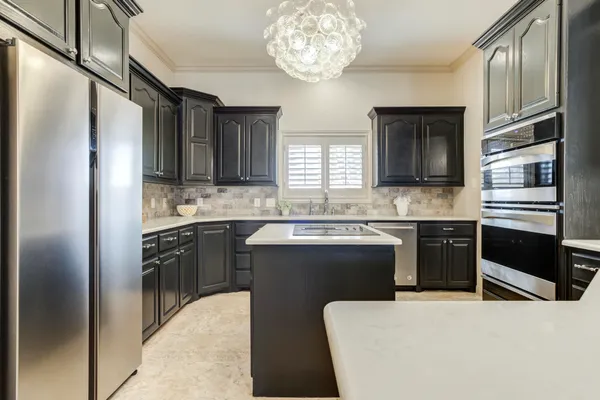 a kitchen with stainless steel appliances granite countertop a stove and a sink