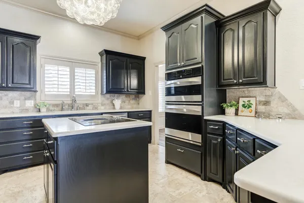 a kitchen with a sink stove and refrigerator