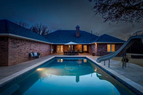 a view of swimming pool with seating area