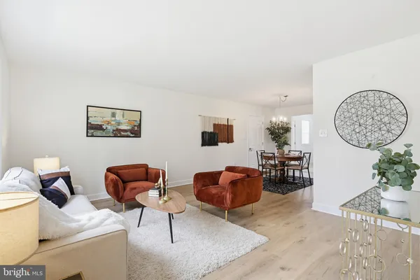 a living room with furniture a couch and a potted plant