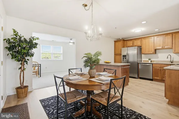 a view of a livingroom with furniture and a kitchen view