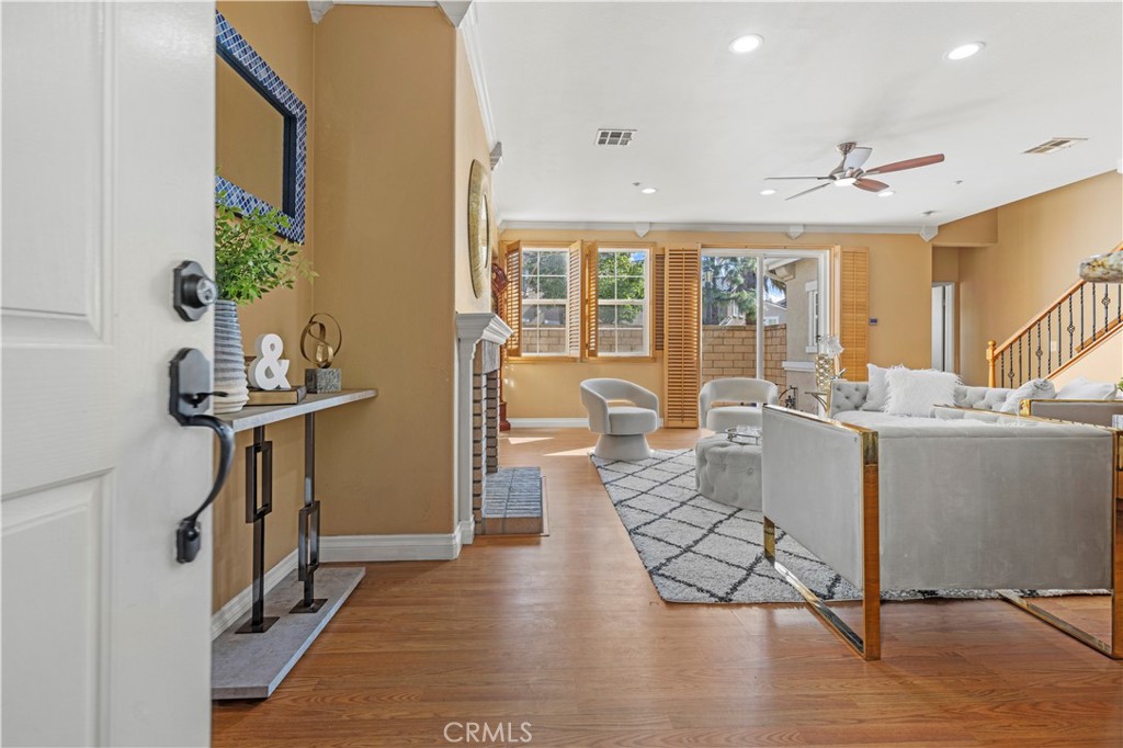 11450 Church Street, Unit 23 Rancho Cucamonga, CA 91730 - Photo 2 of 44 a living room with furniture a dining table wooden floor and a chandelier