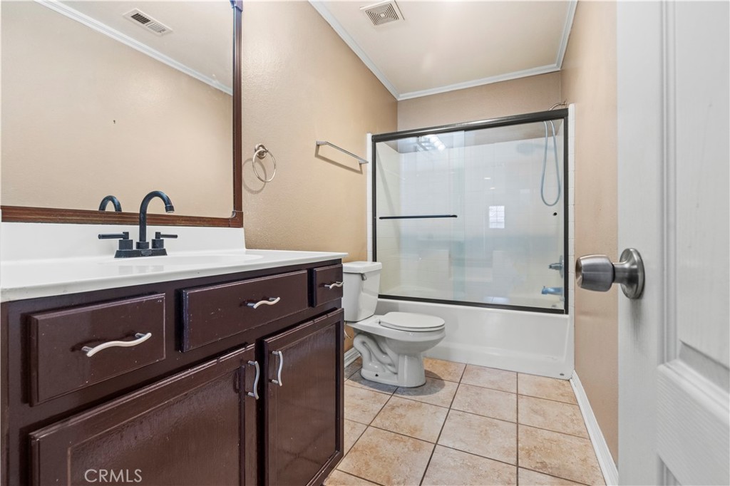 11450 Church Street, Unit 23 Rancho Cucamonga, CA 91730 - Photo 26 of 44 a bathroom with a sink a toilet and shower