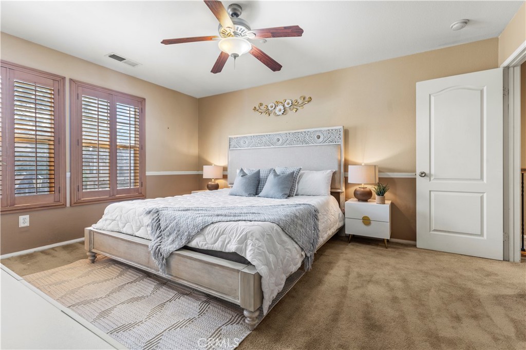 11450 Church Street, Unit 23 Rancho Cucamonga, CA 91730 - Photo 30 of 44 a bed room with a bed and a chandelier