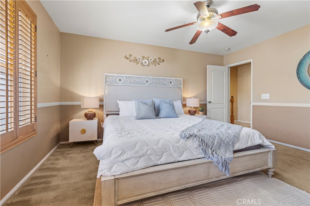11450 Church Street, Unit 23 Rancho Cucamonga, CA 91730 - Photo 31 of 44 a bedroom with a bed and a chandelier