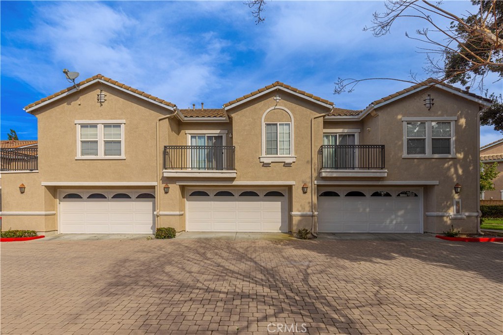 11450 Church Street, Unit 23 Rancho Cucamonga, CA 91730 - Photo 38 of 44 a front view of a house with a yard and garage