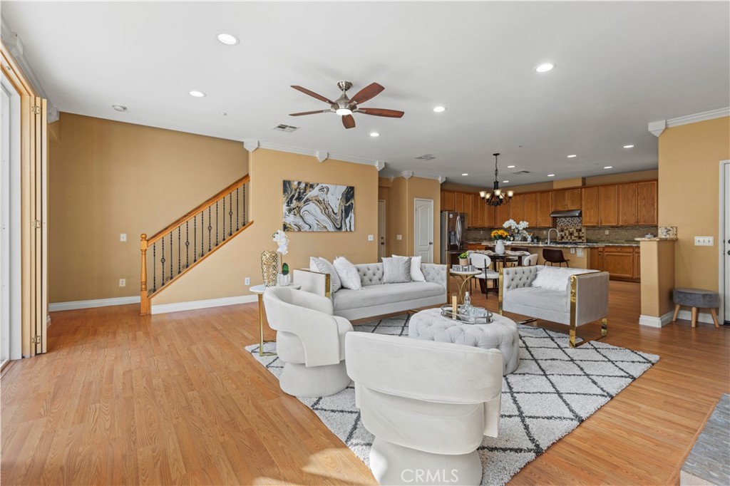 11450 Church Street, Unit 23 Rancho Cucamonga, CA 91730 - Photo 5 of 44 a living room with couches and kitchen view with wooden floor