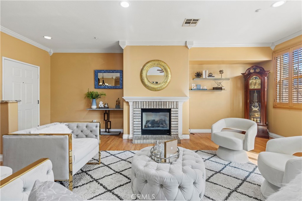 11450 Church Street, Unit 23 Rancho Cucamonga, CA 91730 - Photo 8 of 44 a living room with furniture a fireplace and a flat screen tv