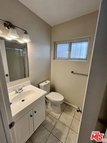 a bathroom with a sink toilet and mirror