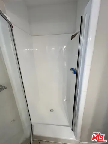 a bathroom with a shower and tub
