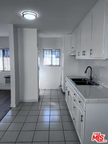 a kitchen with a sink a stove and cabinets