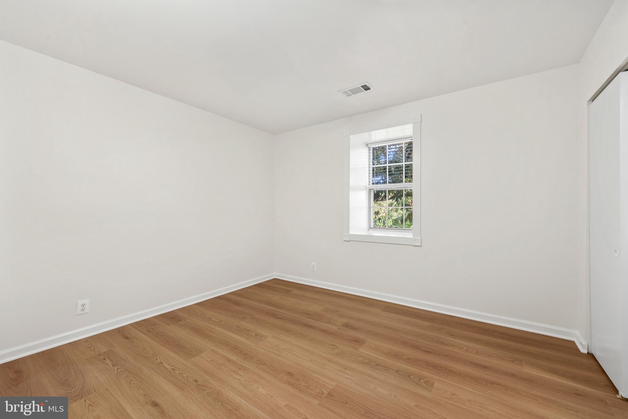 4619 28th Road South, Unit C Arlington, VA 22206 - Photo 13 of 31 an empty room with wooden floor and windows