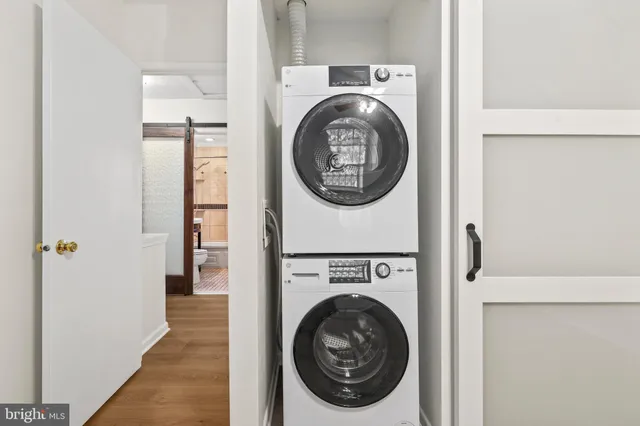 a view of a hallway with washer and dryer